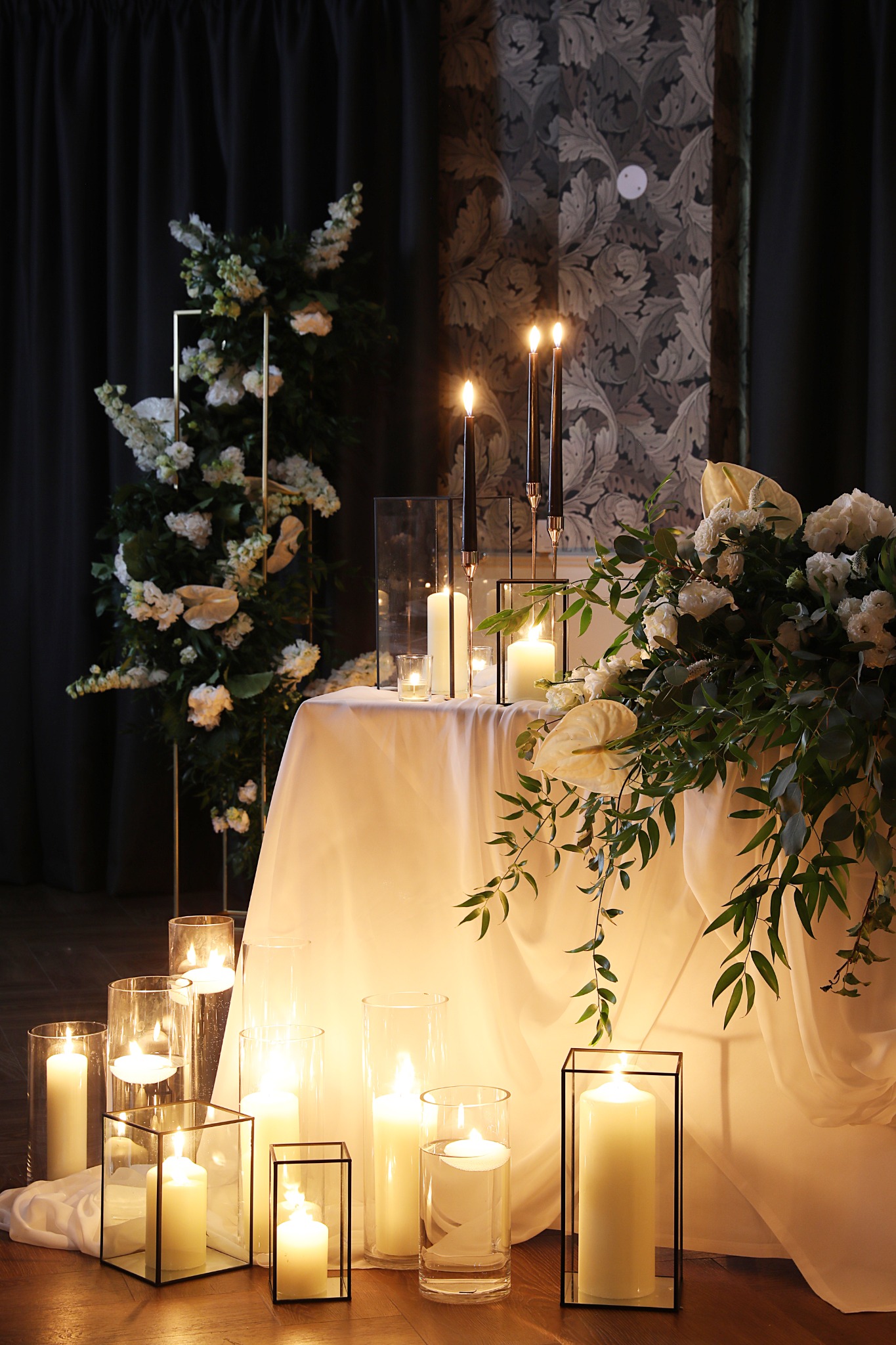Warm candlelit wedding setting with flowers and lanterns