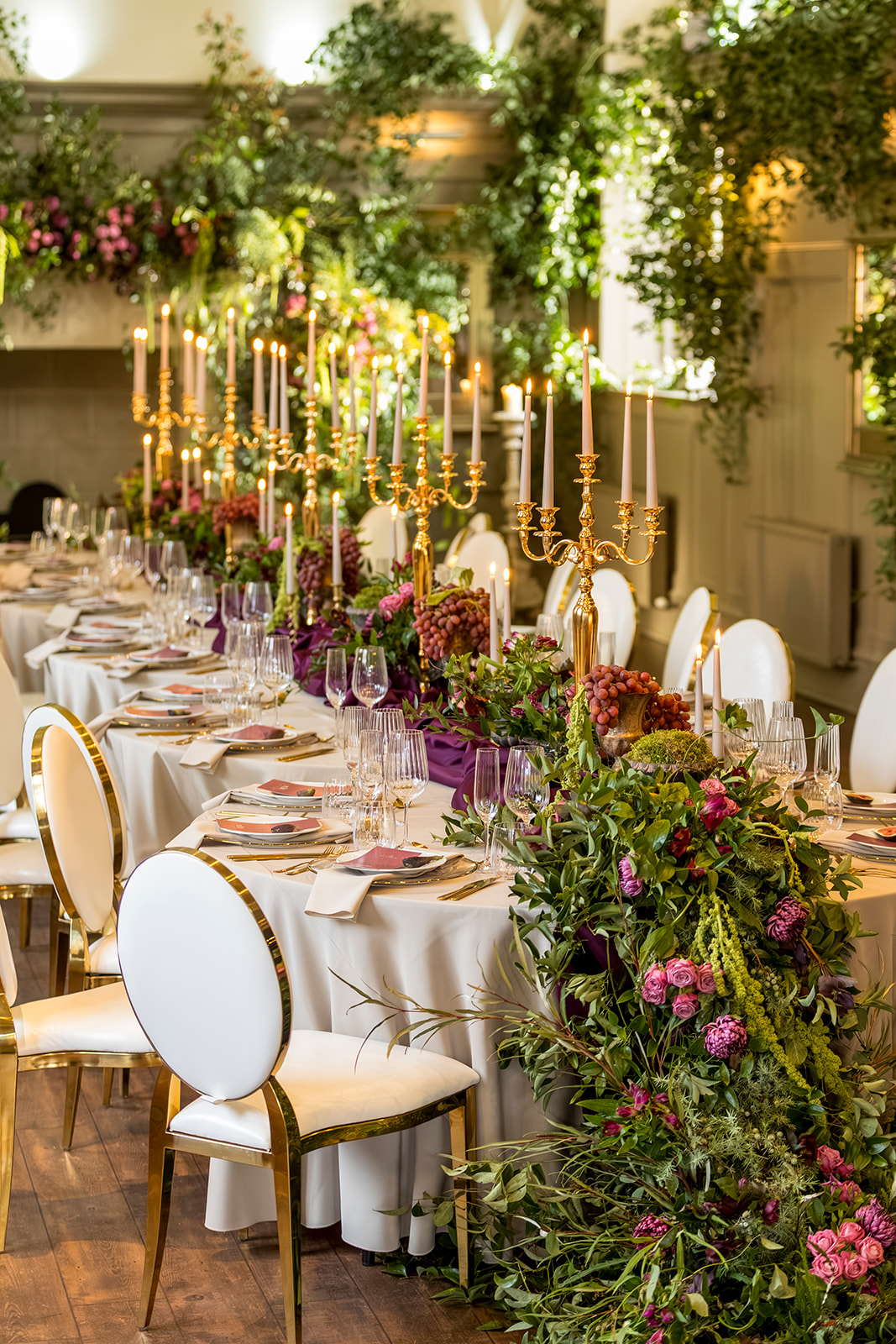 Reception table styled with flowers and candles at Ellingham Hall